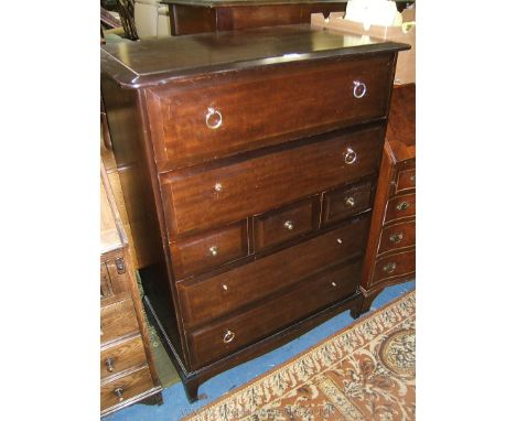 A Stag bedroom Chest of seven Drawers, with two long over three short over two long drawers with brass knobs and handles, sta