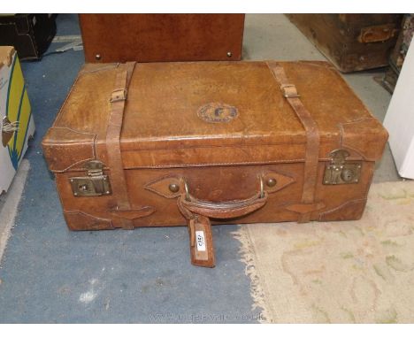 A vintage leather belted Suitcase