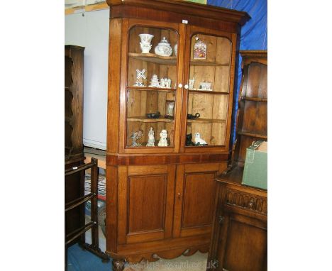 A good Victorian Oak and Mahogany floor standing Corner Cupboard with two pairs of double doors, having moulded cornice over 