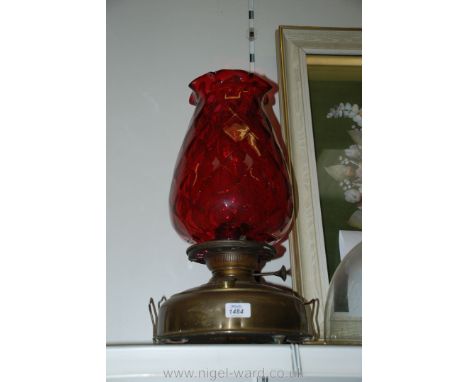 A Cranberry glass Oil Lamp with tulip glass shade