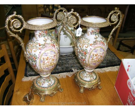 A pair of reproduction ceramic Vases with brass rims and handles on brass bases, 19" tall