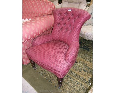 A pretty 19th c. upholstered Nursing Chair in red ground geometric shadow pattern fabric with button back, standing on turned