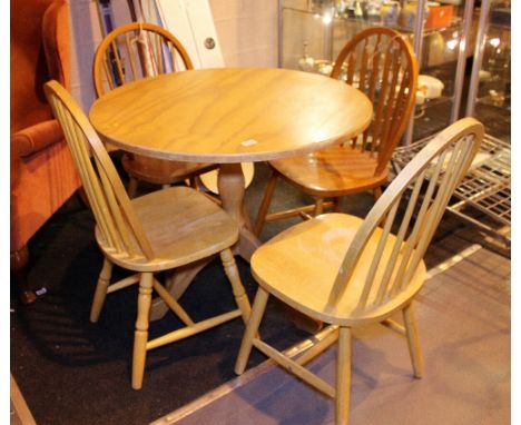 DINING TABLE AND CHAIRS. Pine circular kitchen dining table with four matching stick back dining chairs, D: 89 cm