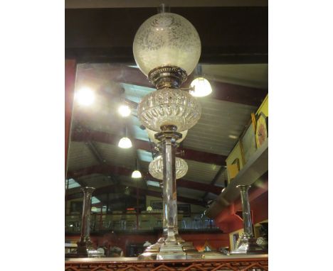 A Hinks & Sons silver pedestal oil lamp with foliate frosted glass shade over cut glass reservoir to faceted stem.  Sheffield