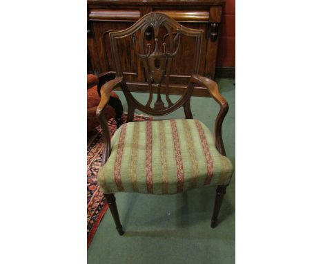 A set of eight George III Revival Edwardian mahogany dining chairs the carved shield back rests over a serpentine front seat 