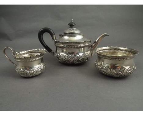 A Josiah Williams and Co Victorian three piece silver bachelor's tea service consisting teapot with ebonised handle and knop,