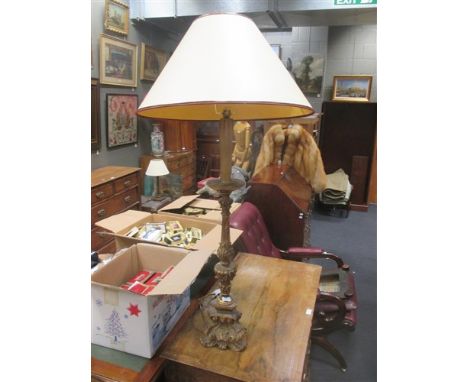 A carved gilt wood lamp