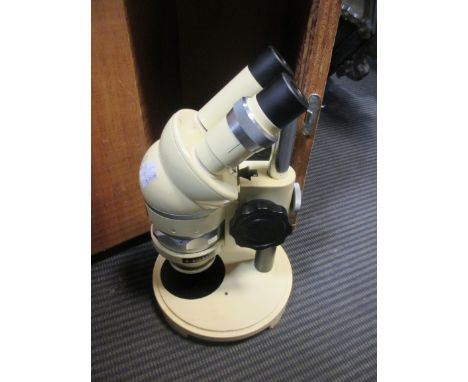 A 'Wild' cream finish binocular microscope, no. M5-97457, with later wooden box