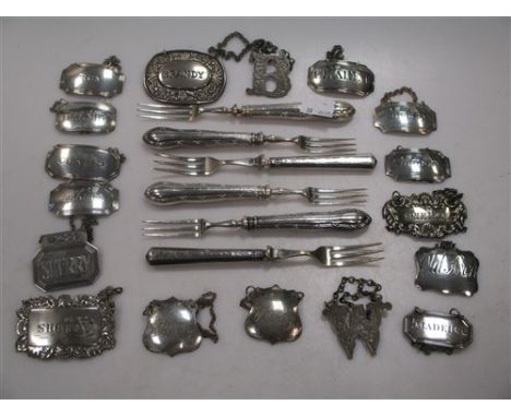 A set of four silver decanter labels together with various other labels and small silver