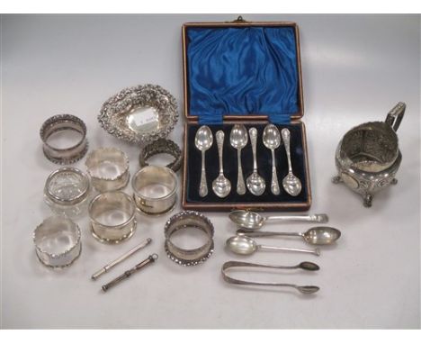 including 7 napkin rings, a bon bon dish, a cream jug, some flatware, a tooth pick, a swizzle stick and a silver rimmed glass