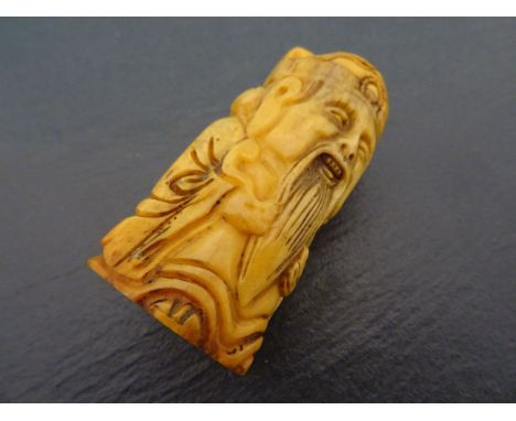 Bone netsuke of a man with gold