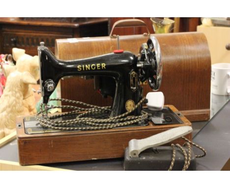 A vintage singer sewing machine and mahogany plant stand 