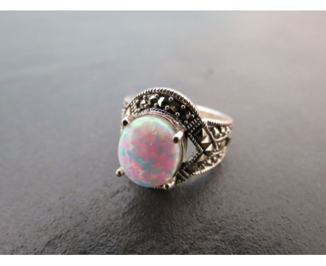 A silver Marcasite and large central opal ring in the Art Deco style 