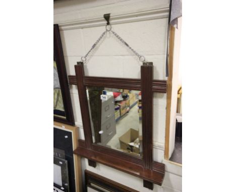 A vintage oak mirror with bevelled glass