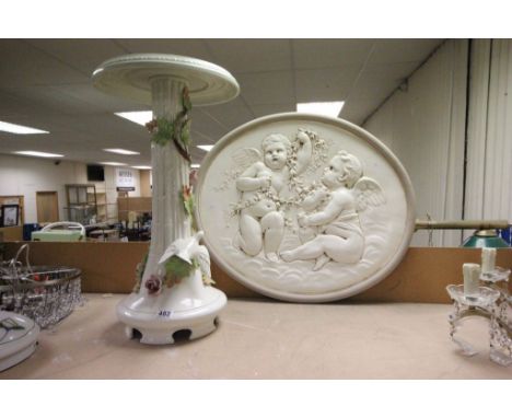 A contemporary ceramic jardiniere stand with flower and bird decoration and a plaster plaque with classical decoration.