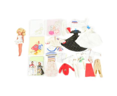 Sindy - a vintage Pedigree made Sindy doll with blonde hair and eyes to the right, numbered 033055X Clothes to include Tennis