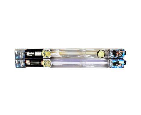 Star Wars - x2 boxed Hasbro made battery operated light up lightsabers comprising Luke Skywalker and Darth Vader. Each measur