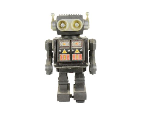 Tinplate toys - A vintage Japanese Horikawa 'Roto' robot. Features stop-and-go action, rotating body, moving arms, shooting g