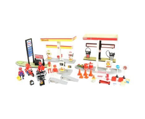 Playmobil - collection of a vintage Playmobil comprising a Shell &amp; Esso petrol station with pumps, cans, tyres, cones, si