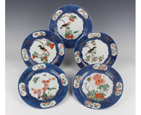 A group of five Chinese famille verte powder blue ground porcelain plates, Kangxi period, each central octalobed panel filled