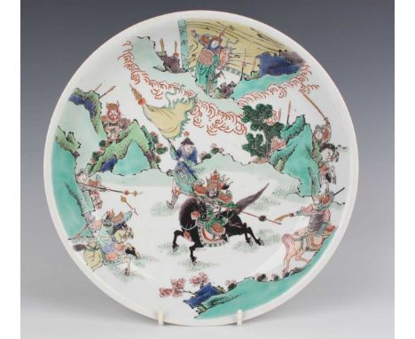 A Chinese famille verte porcelain saucer dish, Kangxi style but later, painted with a battle scene, underglaze blue lingzhi f