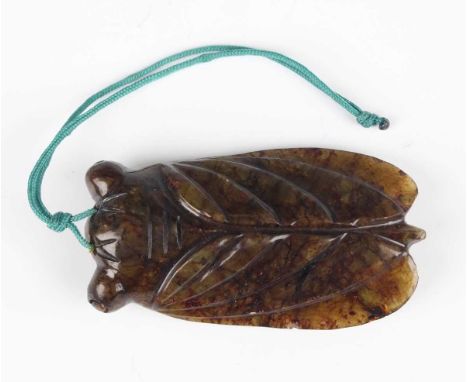 A Chinese carved jade cicada pendant, late Qing dynasty, with carved and incised decoration, the stone of mottled brown, blac