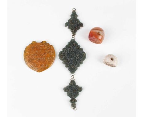 An Islamic dark green jade three-section arm ornament, each piece incised with script, total width 17cm, together with a yell