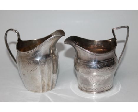 TWO GEORGIAN BRIGHT CUT CREAM JUGS, the first having a panelled styling and dated London 1794 and the second having vacant la