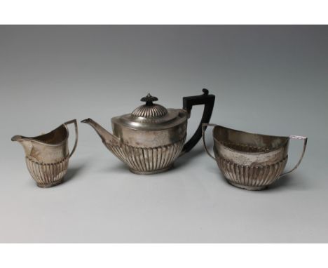 A HALLMARKED SCOTTISH SILVER THREE PIECE TEA SERVICE BY MACAKY &amp; CHISHOLM - EDINBURGH 1895, being of typical half fluted 