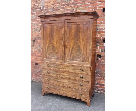 A 19TH CENTURY MAHOGANY LINEN PRESS, the two door upper section opening to a converted interior, the lower section with four 