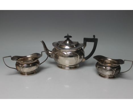 A HALLMARKED SILVER THREE PIECE TEA SERVICE - BIRMINGHAM 1924, all three pieces having shaped and engraved styling, maker's m