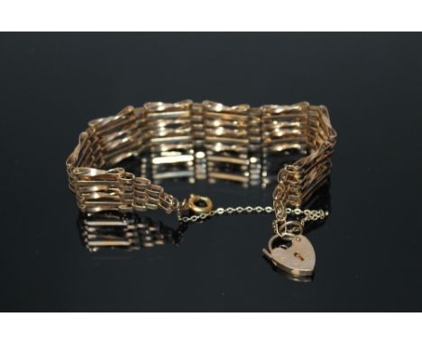 A 9CT GOLD SIX BAR GATE BRACELET, heart shaped clasp with safety chain, approx 9.9 g
Buyers - for shipping pricing on this lo