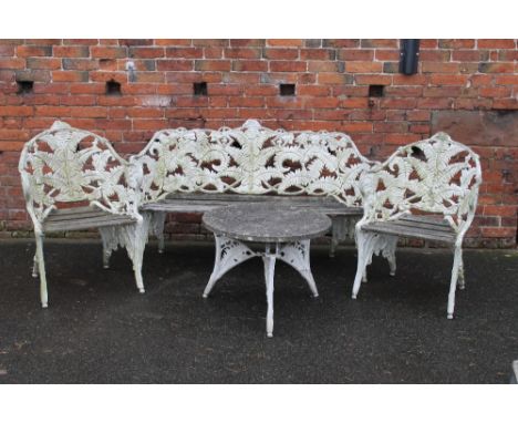 A COALBROOKDALE DESIGN CAST FERN AND BLACKBERRY PATTERN SEAT TOGETHER WITH TWO CHAIRS AND A SMALL TABLE, the curvilinear bran