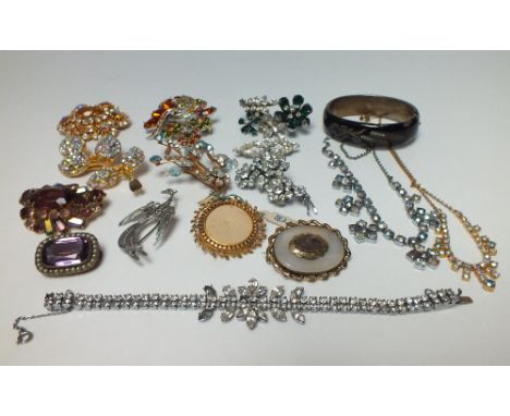 A SELECTION OF VINTAGE COSTUME JEWELLERY, to include a Victorian mourning brooch, a Continental enamel bangle - stamped JB, w