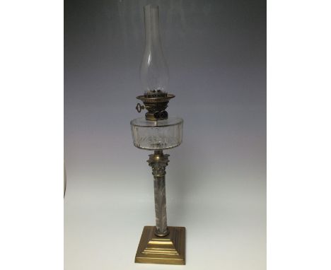 A VICTORIAN COLUMNAR OIL LAMP, with funnel, the marbled effect ceramic column raised on a brass footed base, faceted clear gl