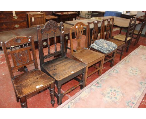 A pair of ladder back back chairs with rush seats, together with four further oak chairs 