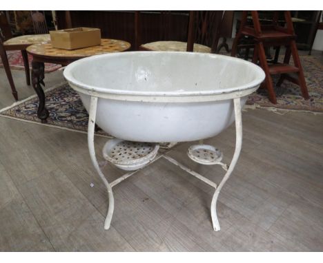 A turn of the 20th Century enamel baby's bath on stand, 52.5cm high, 66cm long 