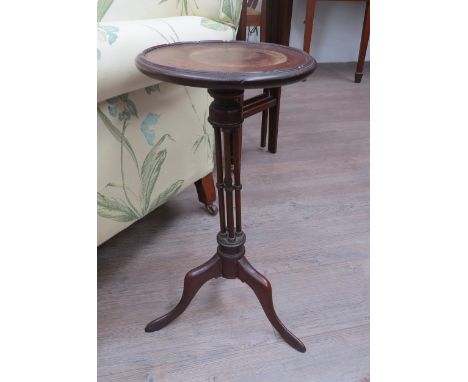 A late 19th / early 20th Century wine table with four pillar support tripod base, top diameter 27.5cm, 57cm tall (water damag