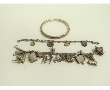 A silver bangle, silver charm bracelet and another (3) 