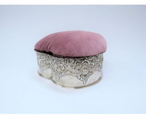 A silver heart shaped trinket box with padded top and embossed bird and foliage body, marks rubbed, 9cm tall x 16cm long 