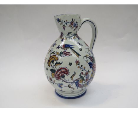 A Gien late 19th Century French Quimper wave jug with bird, butterfly and floral detail, 26cm tall 