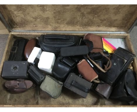 A suitcase containing a collection of vintage cameras.