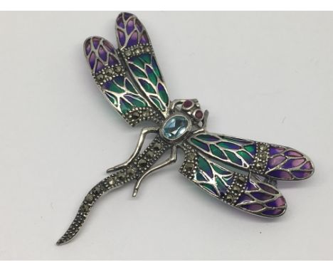 A silver dragonfly brooch set with topaz, coloured enamel, marcasite and ruby eyes