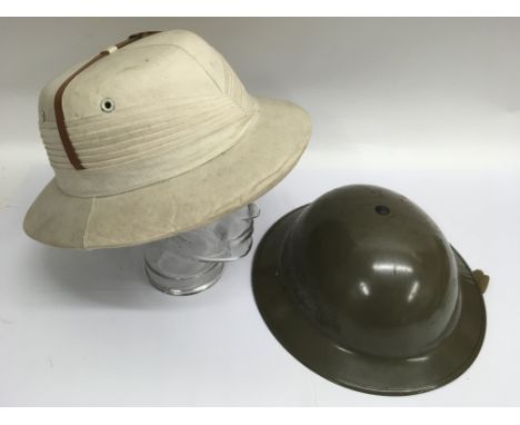 A military tin helmet and pith hat