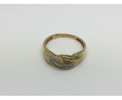 A 14k gold ring set with diamond chips, approx 2.6g and approx size R-S.