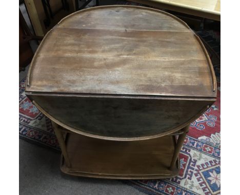 An Ercol light wood, drop leaf tea trolley. Extended approx 93x78cm high, worn