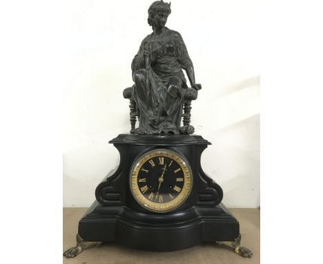 A scroll shaped, black mantle clock with gilt dial, surmounted with a bronzed female figure.Approx 51cm