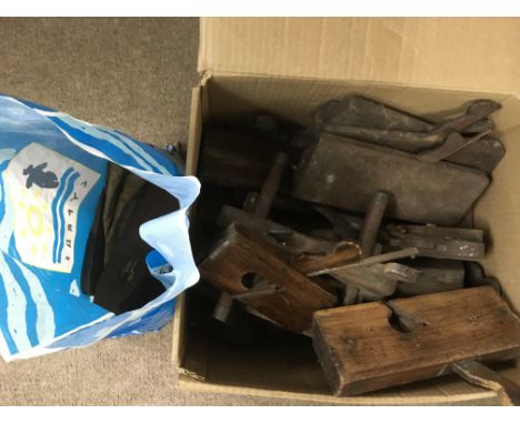 A collection of vintage wood planes and other items.