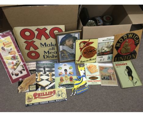A collection of reproduction advertising signs and some vintage tins.