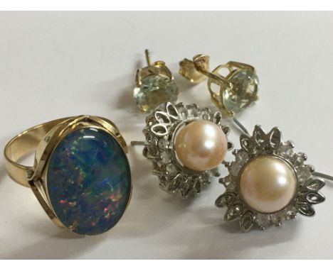 A large 9ct Gold opal ring, a large pair of diamond stone solitaire earrings and a large pair of pearl and diamond earrings